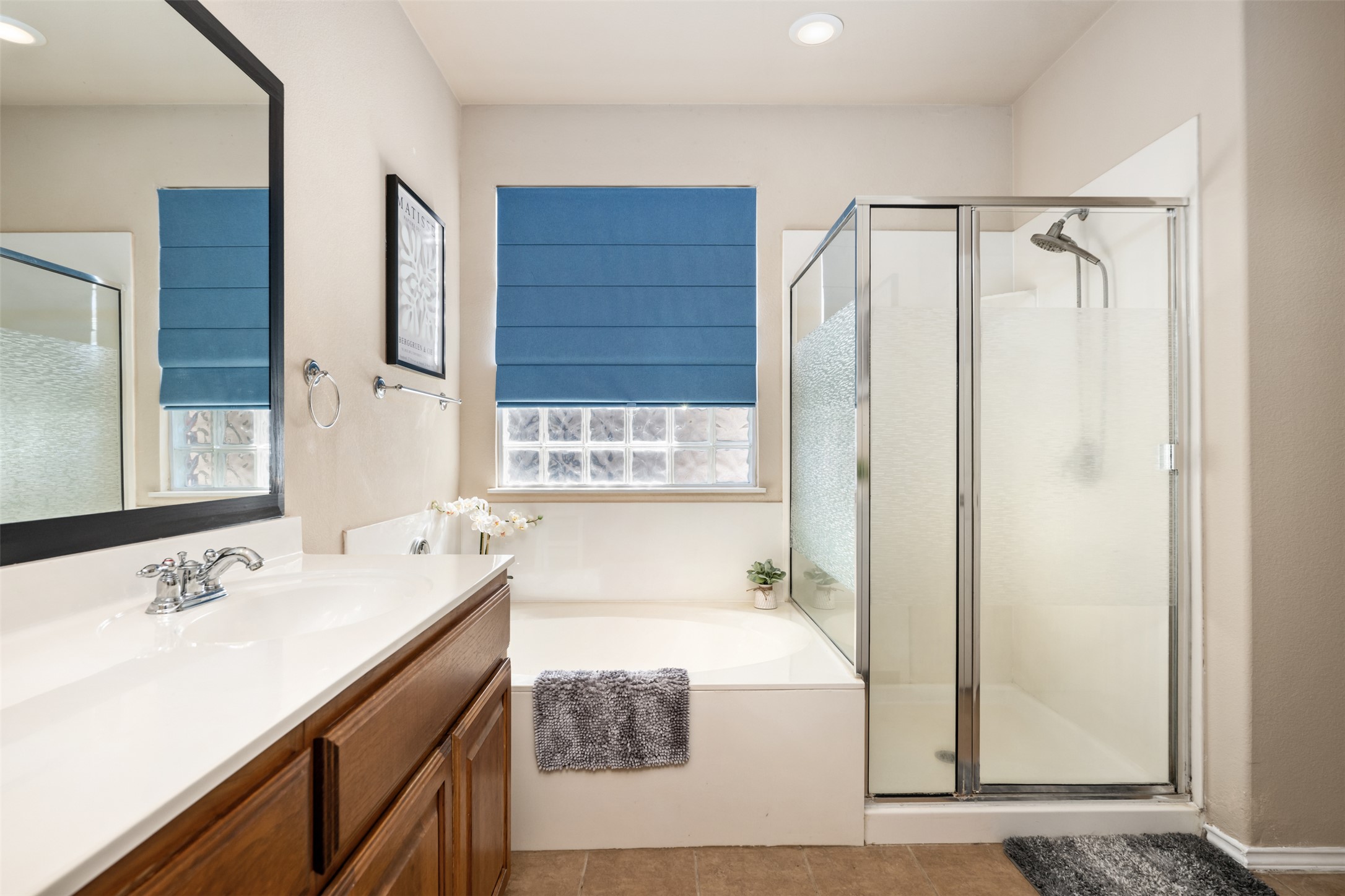 18300 Shallow Pool Drive Pflugerville, TX 78660 - Photo 21 of 40 a bathroom with a sink a mirror and a shower