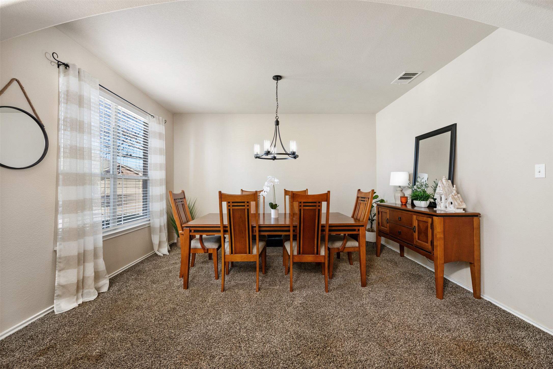 18300 Shallow Pool Drive Pflugerville, TX 78660 - Photo 4 of 40 a dining room with furniture a chandelier and window