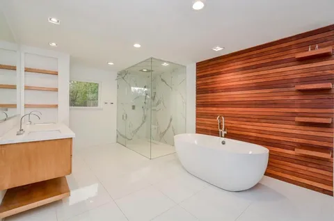 a bathroom with a bathtub and shower