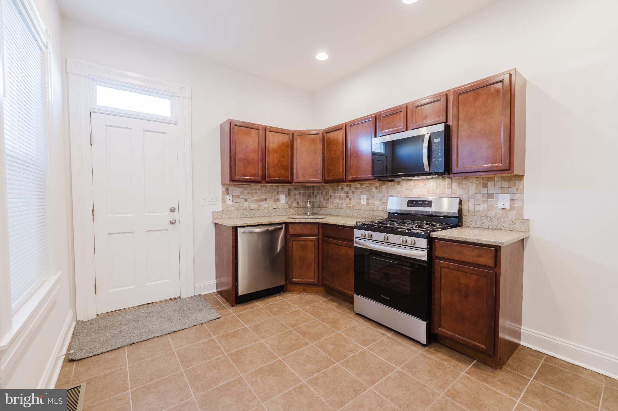 1237 North Broadway Baltimore, MD 21213 - Photo 7 of 25 Modern kitchen with warm wood cabinetry.
