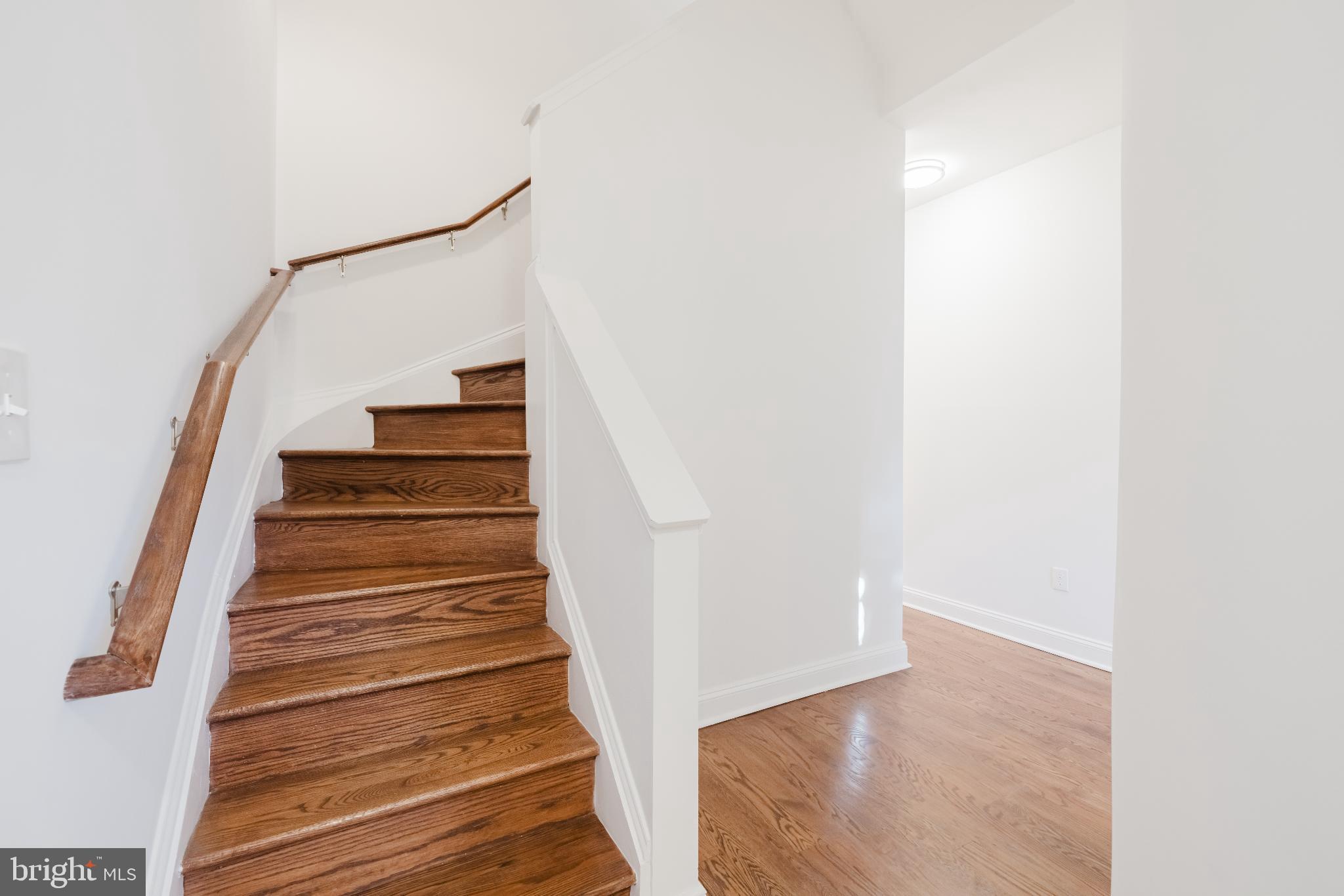 1237 North Broadway Baltimore, MD 21213 - Photo 9 of 25 Elegant staircase leading to bright spaces.