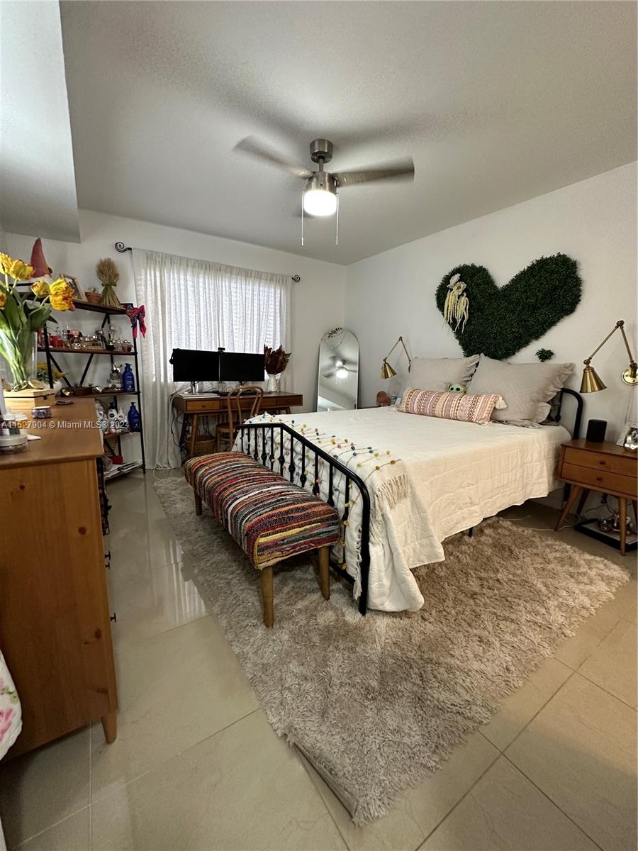 15821 Southwest 104th Terrace, Unit 203 Miami, FL 33196 - Photo 11 of 25 a bedroom with a bed and window