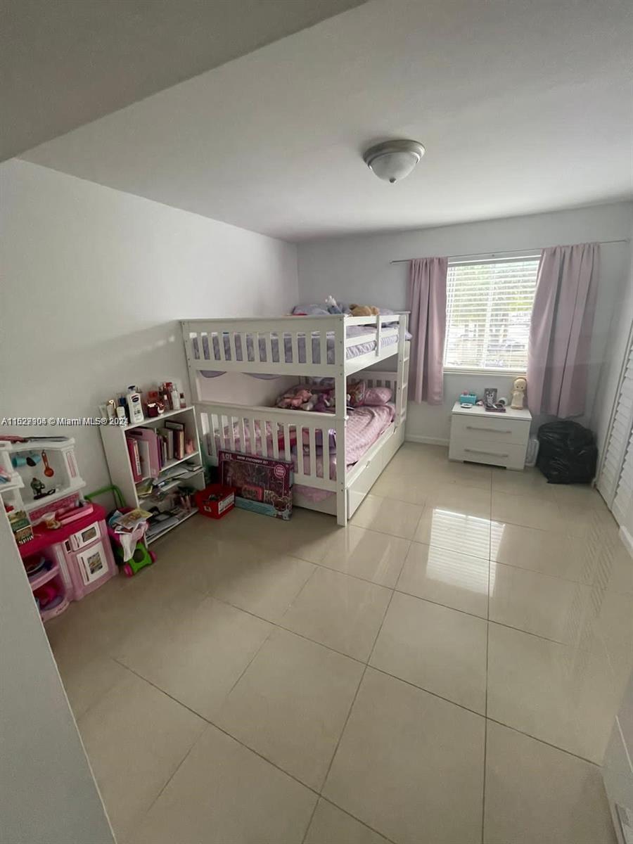 15821 Southwest 104th Terrace, Unit 203 Miami, FL 33196 - Photo 15 of 25 a view of a livingroom with toys and a couch