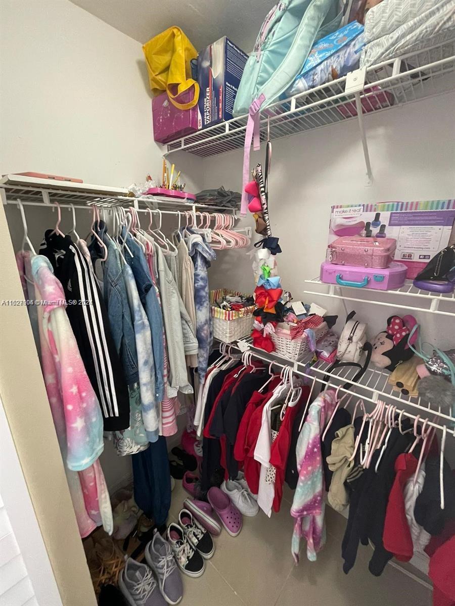 15821 Southwest 104th Terrace, Unit 203 Miami, FL 33196 - Photo 16 of 25 a view of walk in closet with clothes