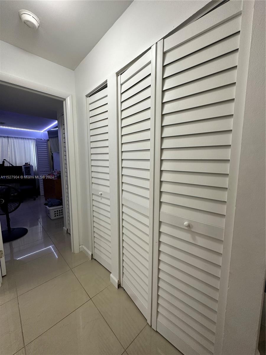15821 Southwest 104th Terrace, Unit 203 Miami, FL 33196 - Photo 19 of 25 a view of a hallway with closet