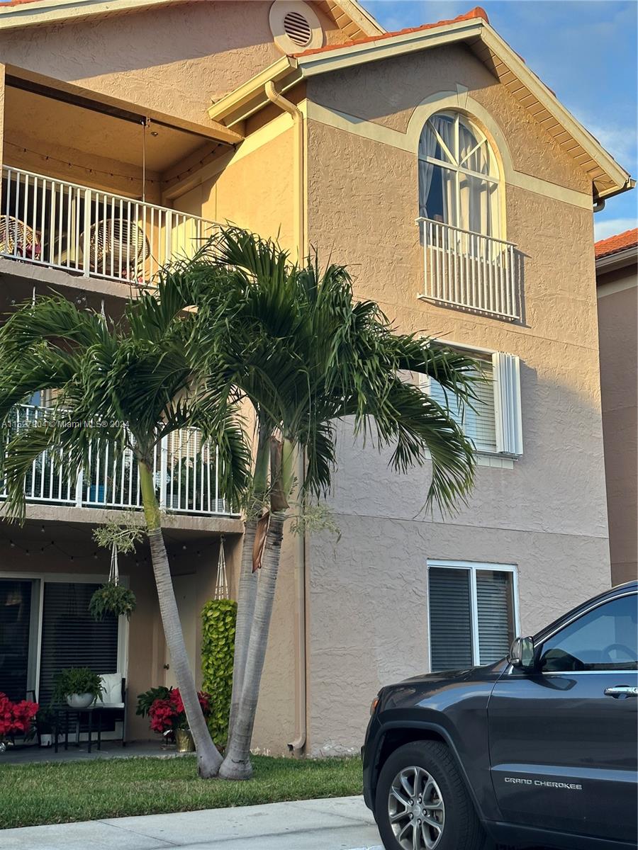 15821 Southwest 104th Terrace, Unit 203 Miami, FL 33196 - Photo 21 of 25 a front view of a house with garden