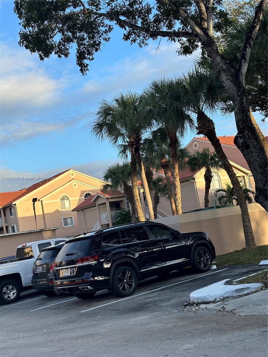 15821 Southwest 104th Terrace, Unit 203 Miami, FL 33196 - Photo 22 of 25 a car parked in front of a house