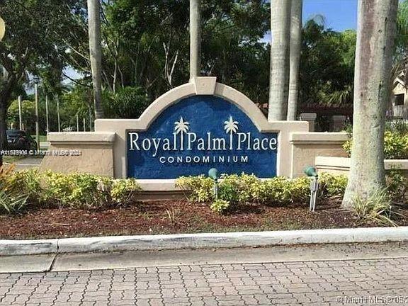 15821 Southwest 104th Terrace, Unit 203 Miami, FL 33196 - Photo 25 of 25 a wooden bench sitting in front of a building
