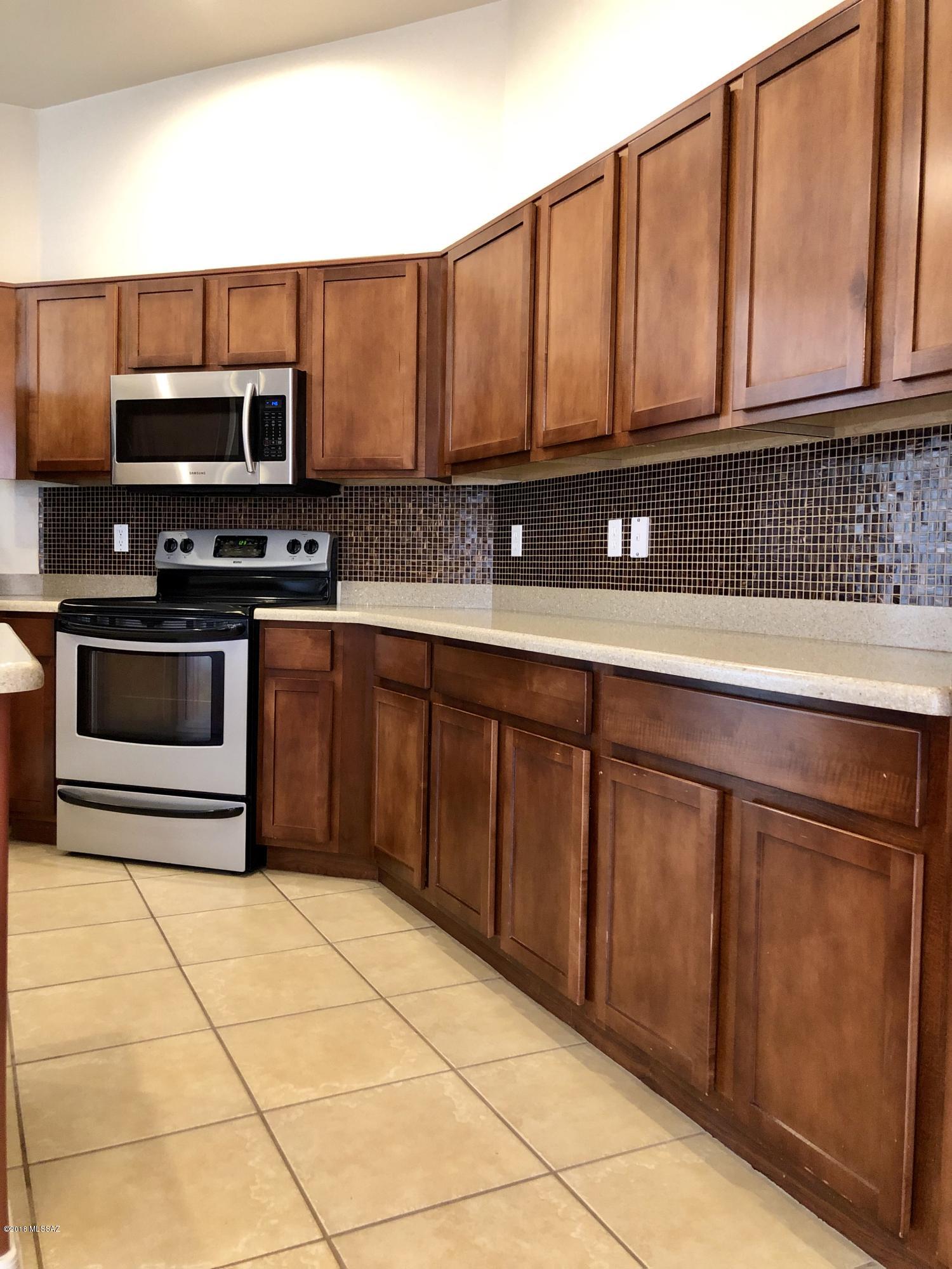 1435 Circulo Sombrero Rio Rico, AZ 85648 - Photo 14 of 40 a kitchen with stainless steel appliances granite countertop a stove cabinets and microwave
