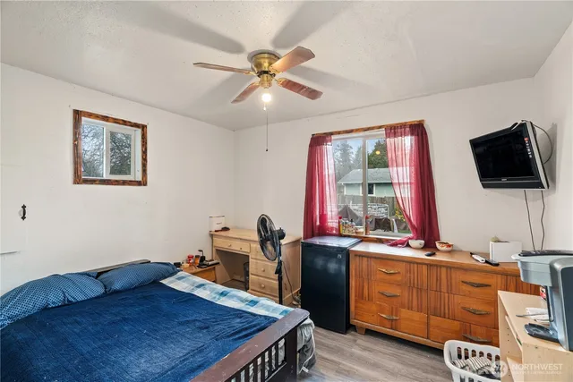 a bedroom with a large bed and a chandelier