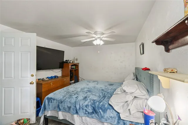 a bedroom with a bed and flat screen tv