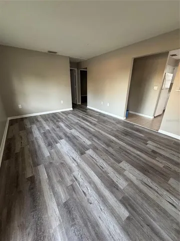 a view of an empty room and wooden floor