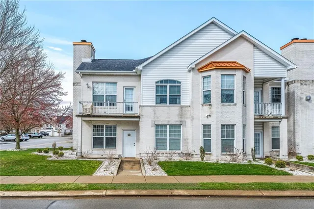 a front view of building with yard and green space