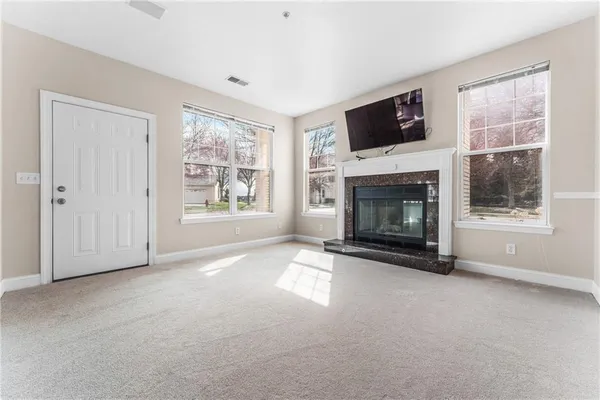 a view of empty room with a fireplace