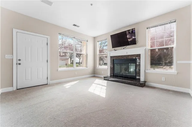 a view of empty room with a fireplace
