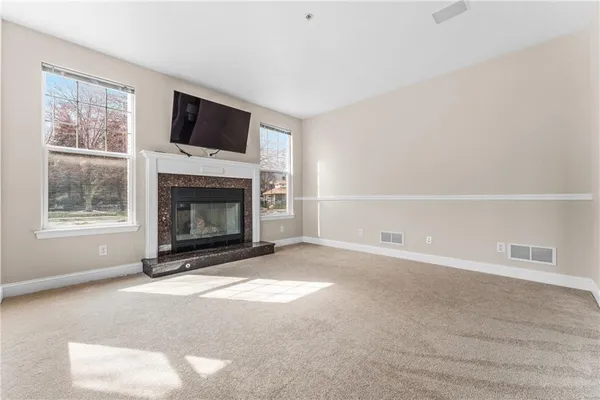 a living room with a fireplace and a flat screen tv