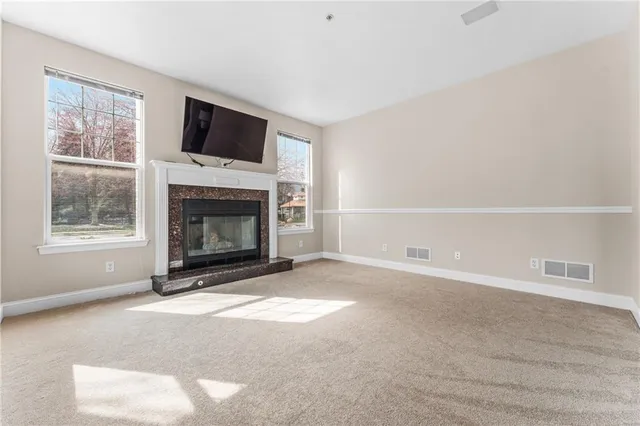 a living room with a fireplace and a flat screen tv