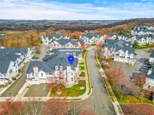 an aerial view of residential houses with outdoor space