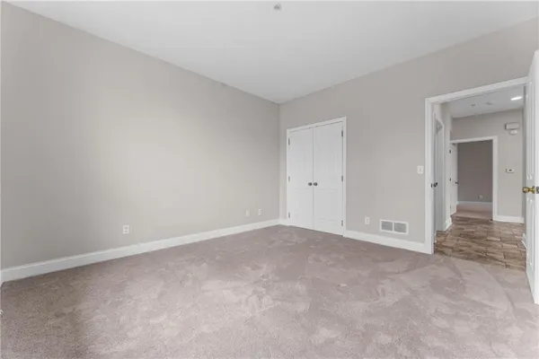 a view of an empty room and closet area