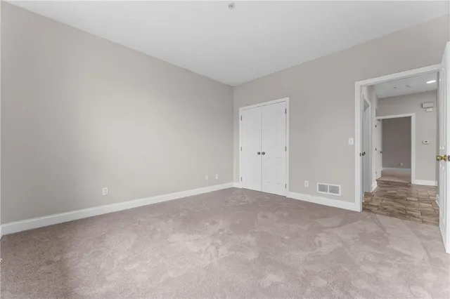 a view of an empty room and closet area