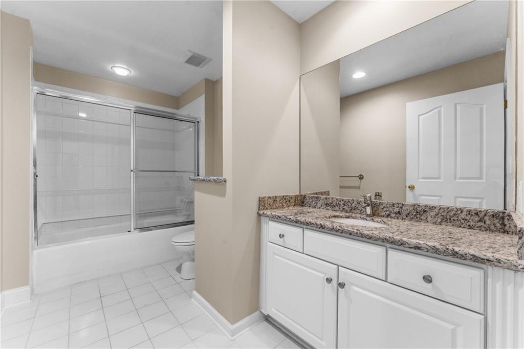216 Adams Pointe Boulevard, Unit 10 Mars, PA 16046 - Photo 25 of 33 a bathroom with a granite countertop sink a toilet and shower