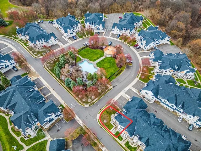 an aerial view of a house with a swimming pool