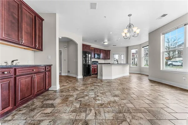 a view of a kitchen with stainless steel appliances granite countertop a refrigerator and cabinets