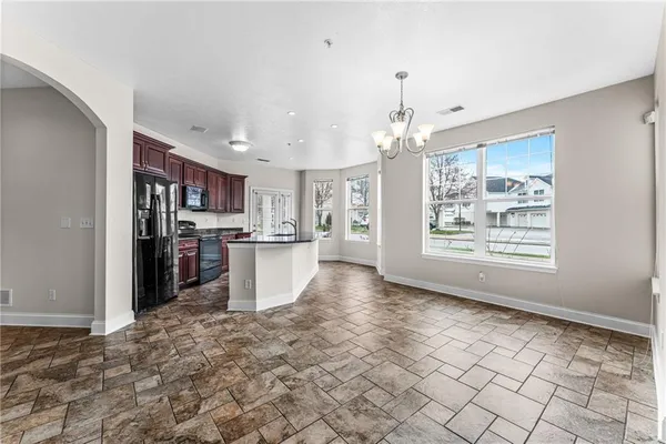 a view of a kitchen with cabinet and a refrigerator