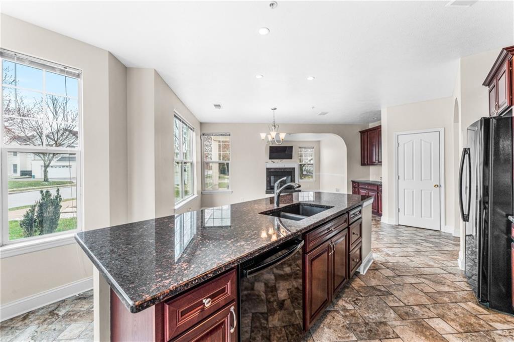 216 Adams Pointe Boulevard, Unit 10 Mars, PA 16046 - Photo 9 of 33 a kitchen with granite countertop kitchen island stainless steel appliances a sink stove and refrigerator