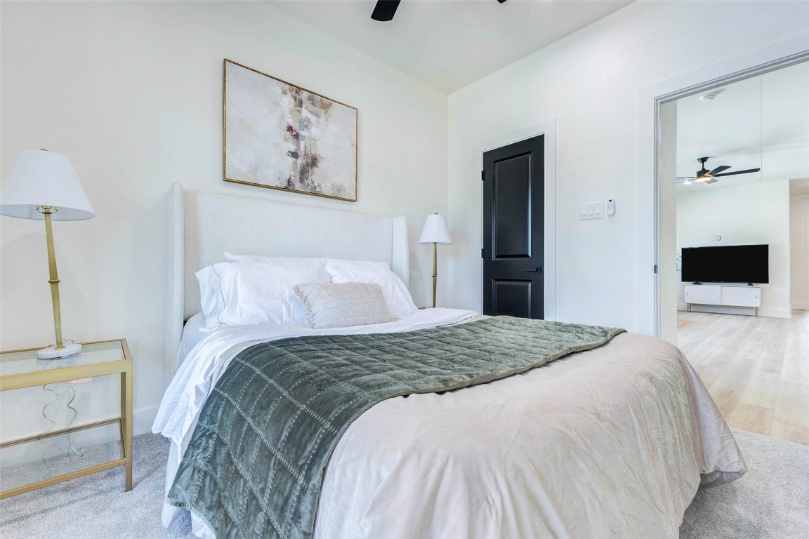 7115 England Street, Unit B Houston, TX 77021 - Photo 12 of 19 A spacious bedroom suite features high ceilings, clean white walls, and a streamlined layout that flows into the second-floor landing.