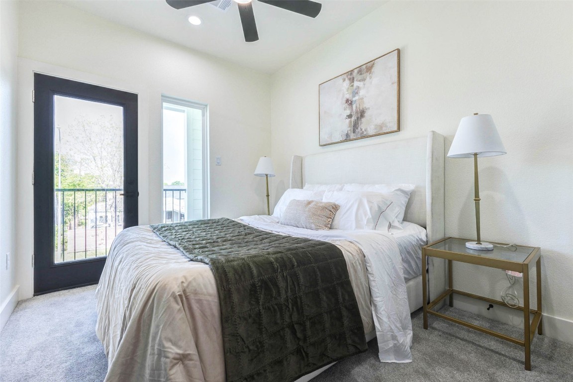 7115 England Street, Unit B Houston, TX 77021 - Photo 15 of 19 This secondary bedroom offers soft neutral carpeting and direct access to a private outdoor space through a full-lite glass door.