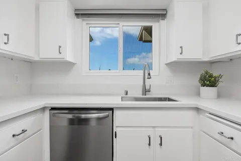 a kitchen with a sink and cabinets