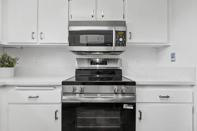 a stove top oven sitting inside of a kitchen