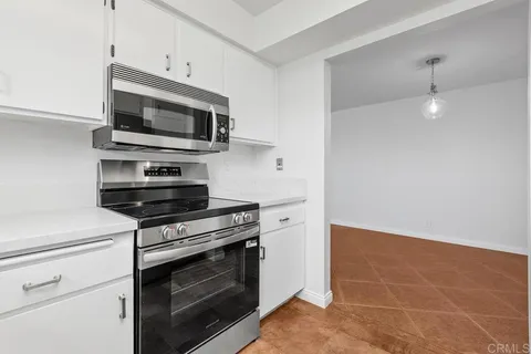 a kitchen with stainless steel appliances a stove microwave and sink