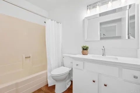 a bedroom with a bed and painting on the wall