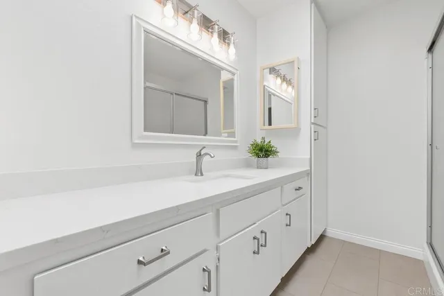 a spacious bathroom with a double vanity sink toilet and a mirror