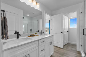 907 West Bright Ridge Ln Street, Unit 1430 St. George, UT 84790 - Photo 19 of 19 Double vanity featuring white cabinetry with brushed nickel hardware and integrated sinks