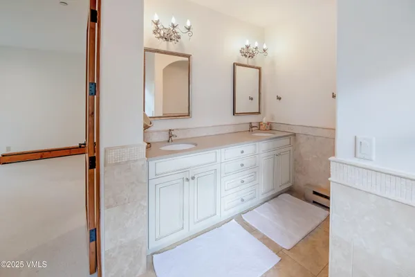 a bathroom with a tub sink and mirror