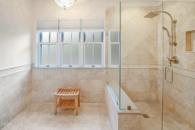 a spacious bedroom with a bed couch and window