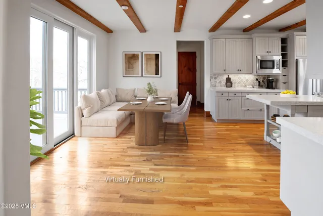 a living room with fireplace furniture and a large window