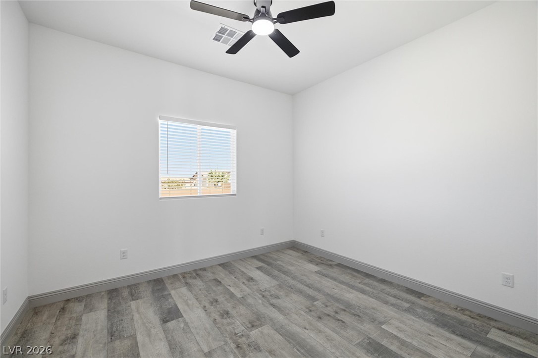 1061 Factory Road Pahrump, NV 89048 - Photo 18 of 41 Clean lines and a functional ceiling fan define this comfortable bedroom space.