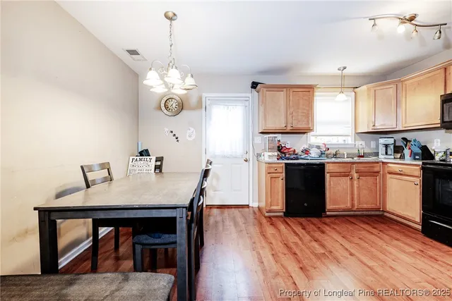 a kitchen with a table and chairs in it