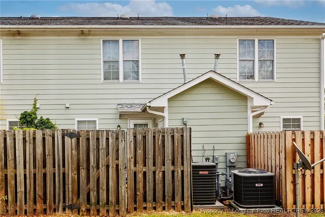 a view of a house with wooden fence
