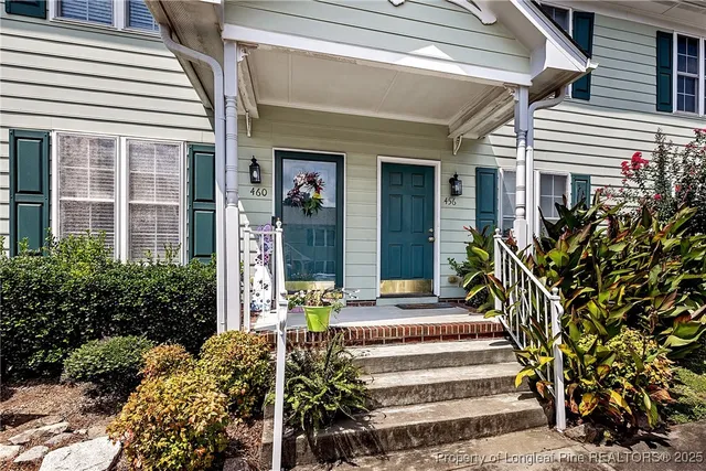 a front view of a house with a garden