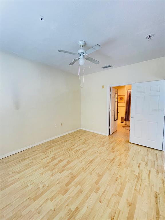 8201 Claire Ann Drive, Unit 202 Orlando, FL 32825 - Photo 11 of 17 a view of empty room with a ceiling fan and entryway
