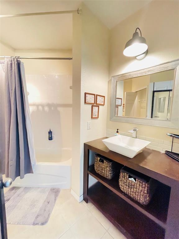 8201 Claire Ann Drive, Unit 202 Orlando, FL 32825 - Photo 14 of 17 a en suite bathroom with a sink a mirror and a bathtub