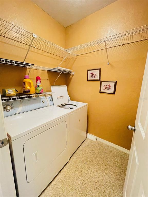 8201 Claire Ann Drive, Unit 202 Orlando, FL 32825 - Photo 15 of 17 a utility room with dryer and washer