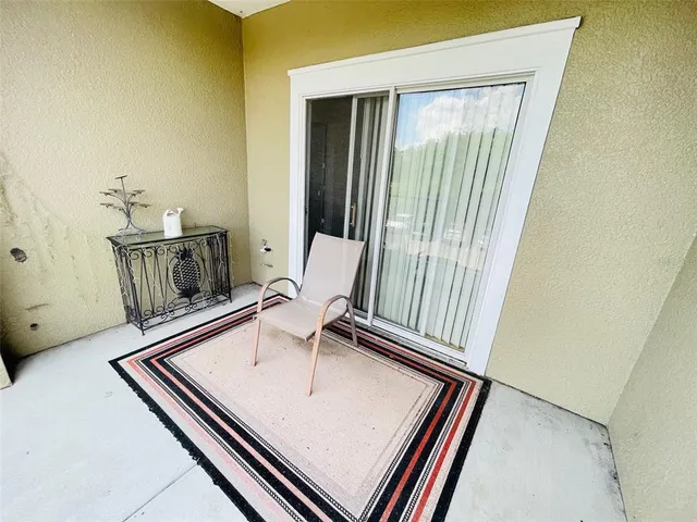 a view of a balcony with furniture and wooden floor