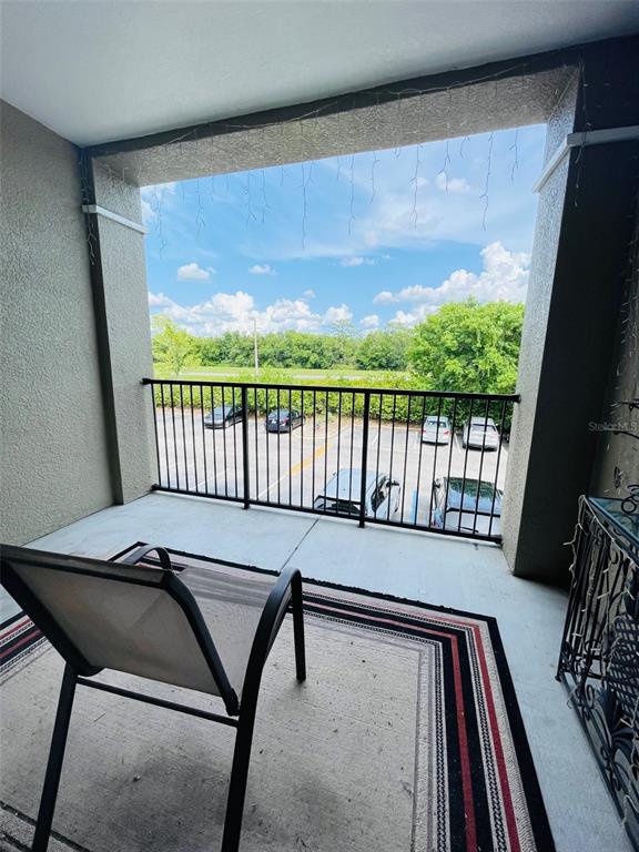 8201 Claire Ann Drive, Unit 202 Orlando, FL 32825 - Photo 17 of 17 a view of a balcony with furniture and wooden floor