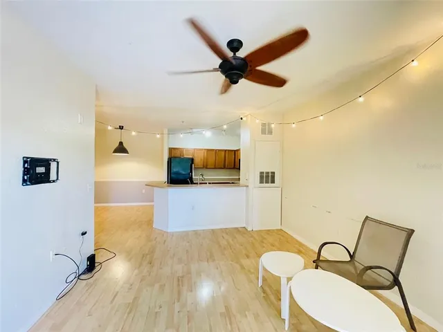 a view of a workspace with wooden floor and furniture